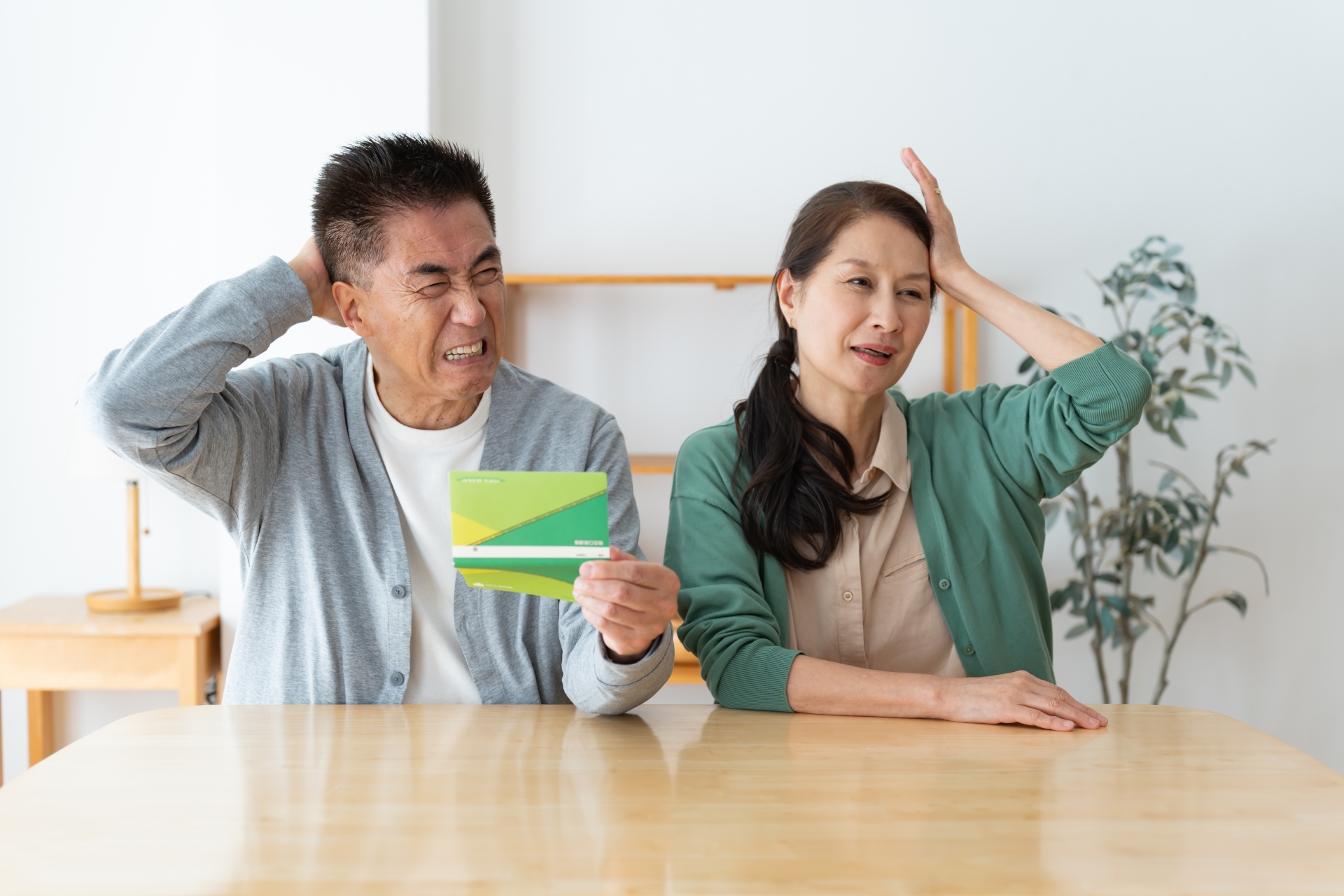 通帳を見る夫婦