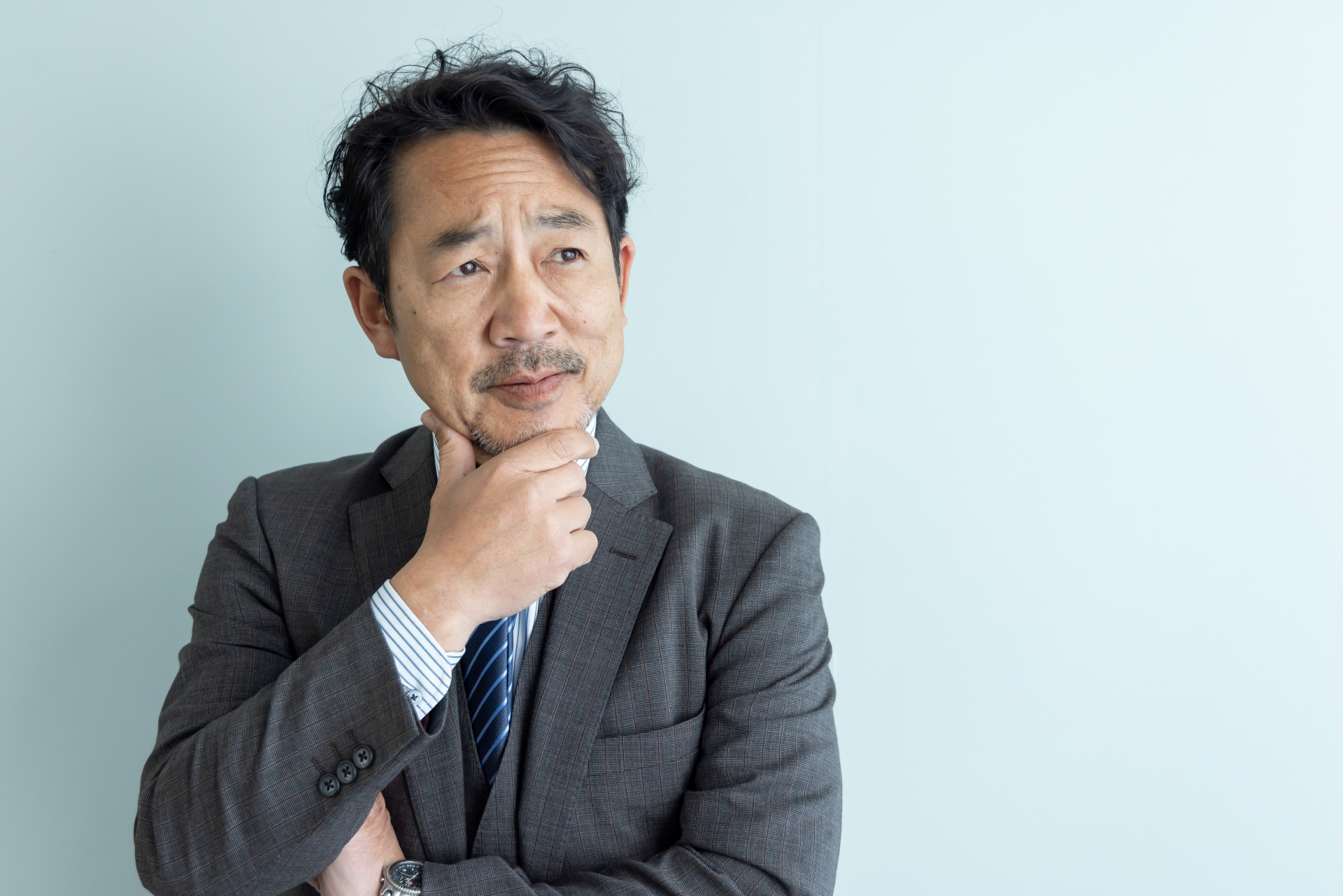 考えるミドルエイジ男性ビジネスパーソン