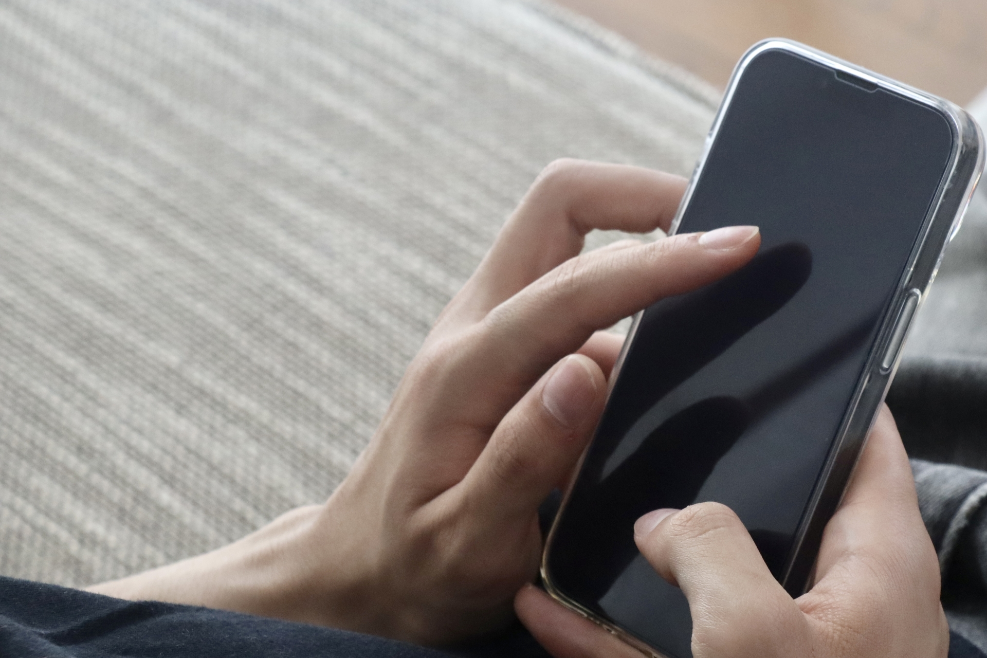 スマホを指さす男性の手