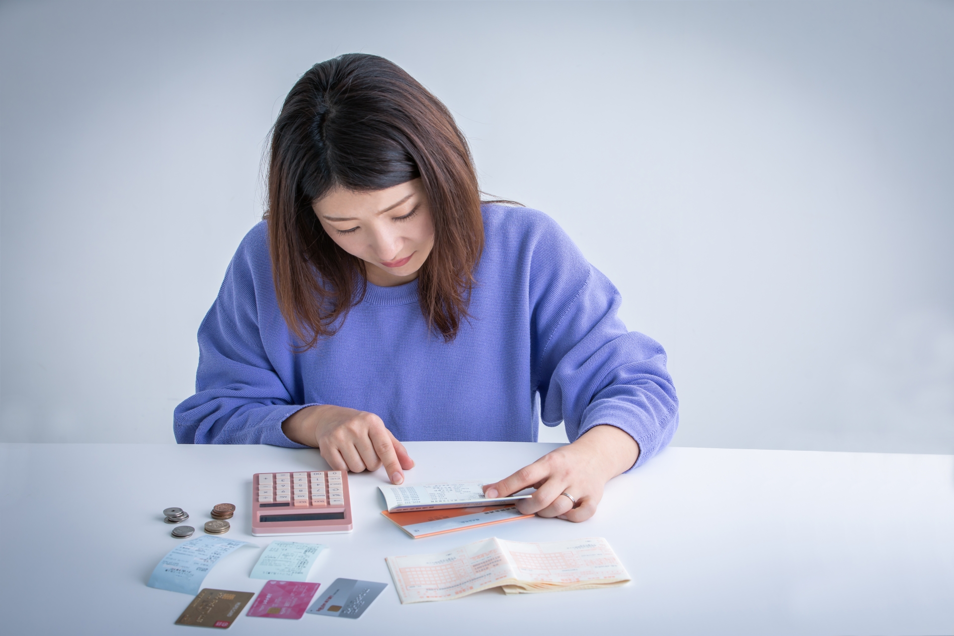 通帳を見て落ち込む女性