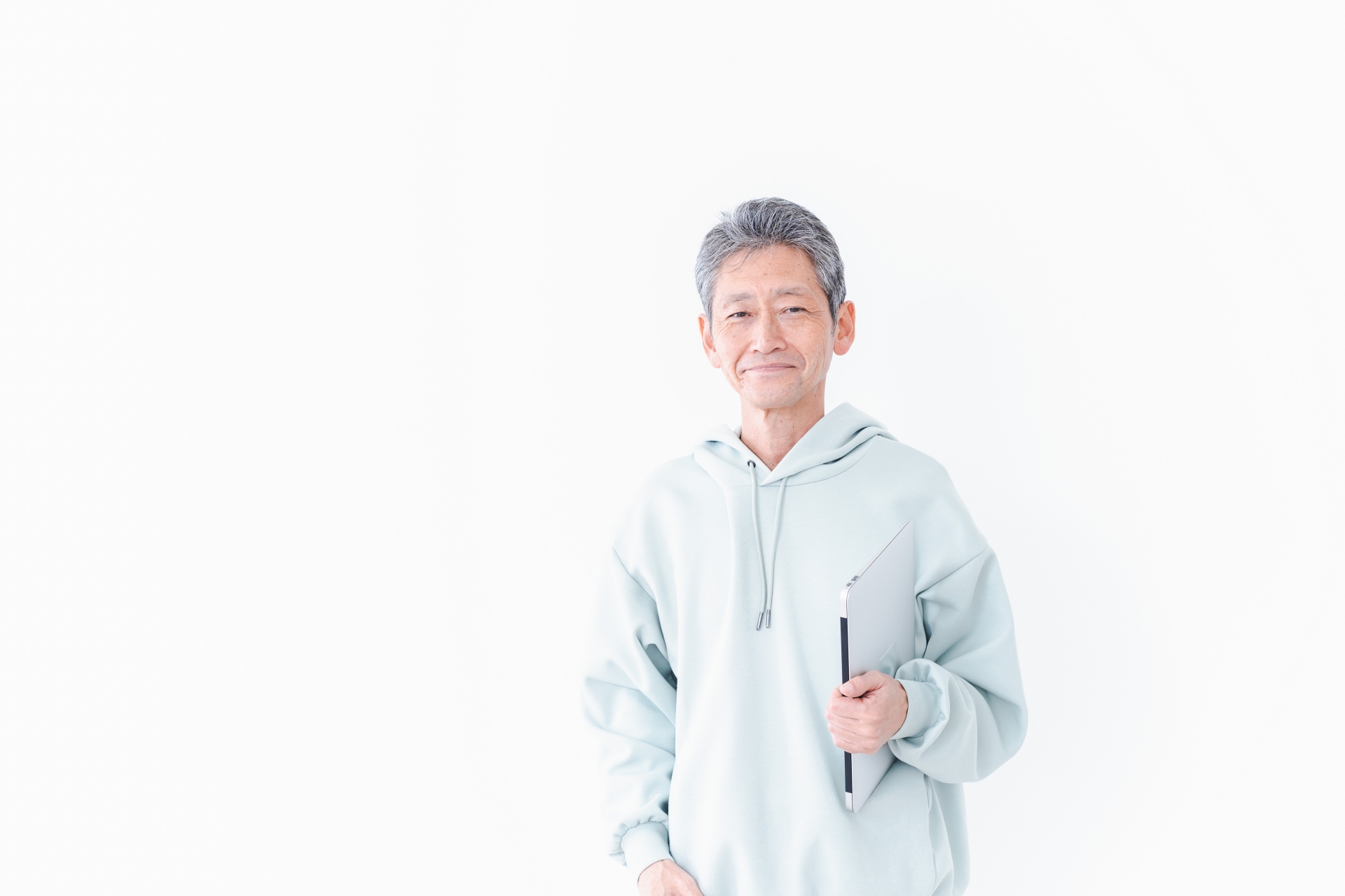 ノートパソコンを持つ高齢の男性