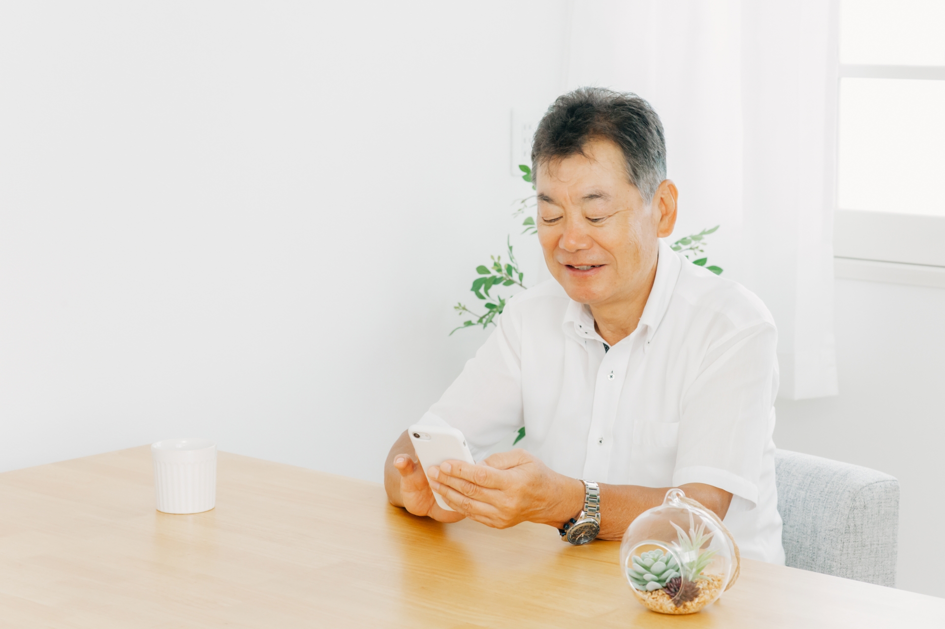 スマホを使う高齢者男性