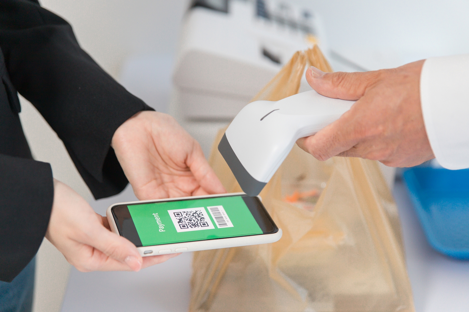 コンビニでスマホ決済する女性（QR）