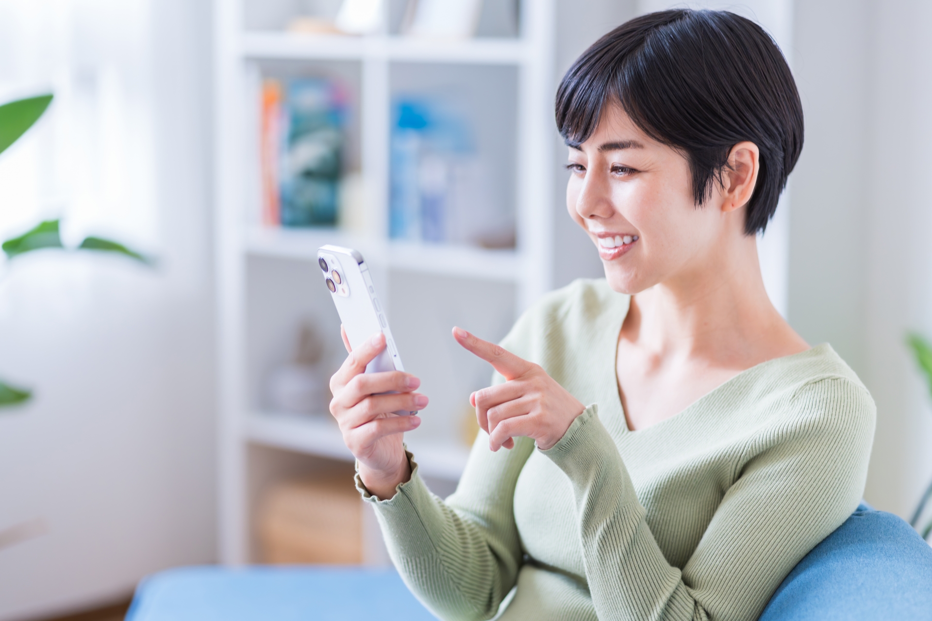 スマホを見て笑顔になる女性
