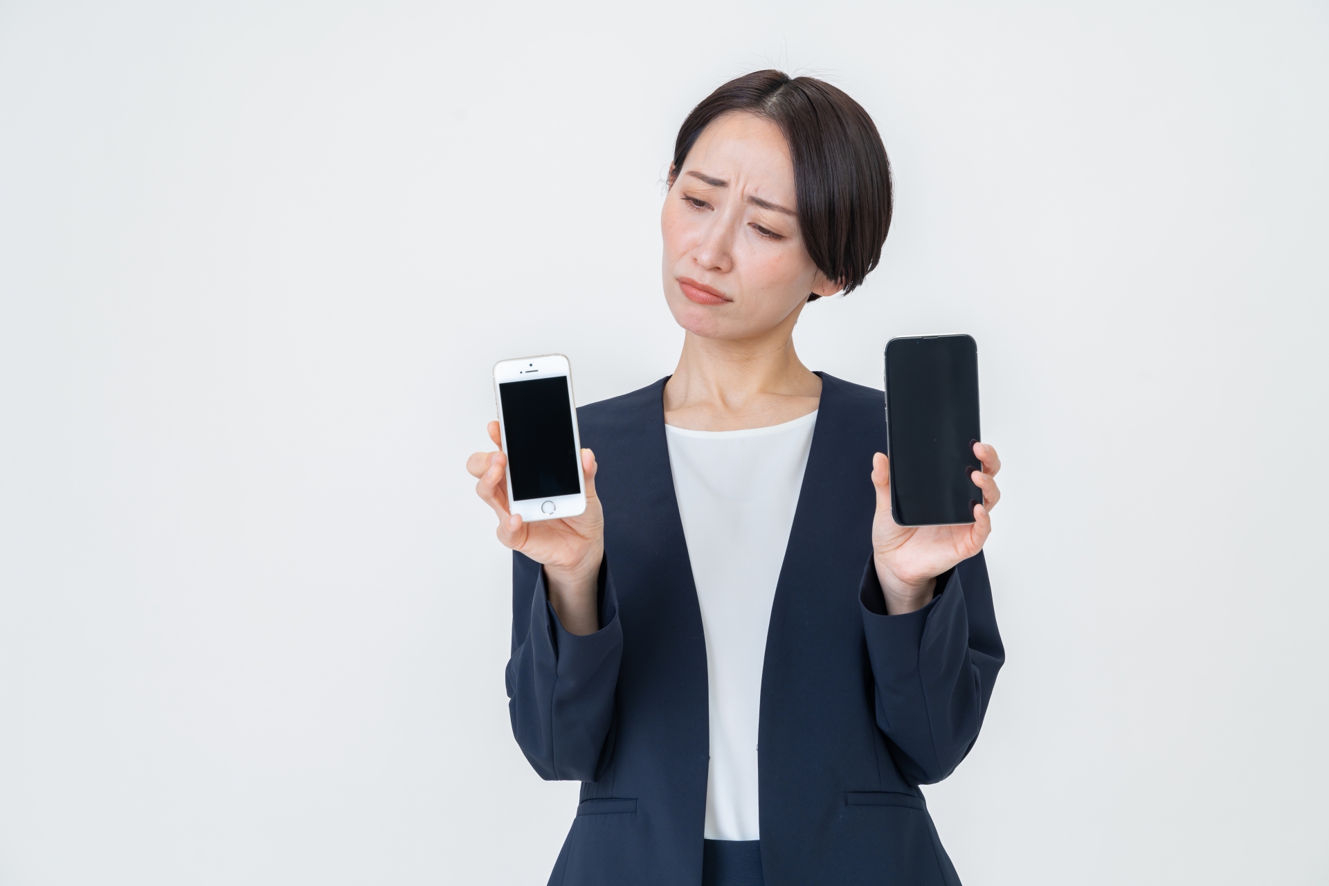 スマホ2台を持つ女性
