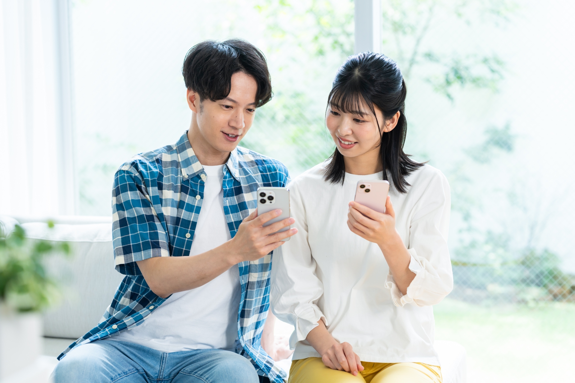 携帯電話を見るカップル