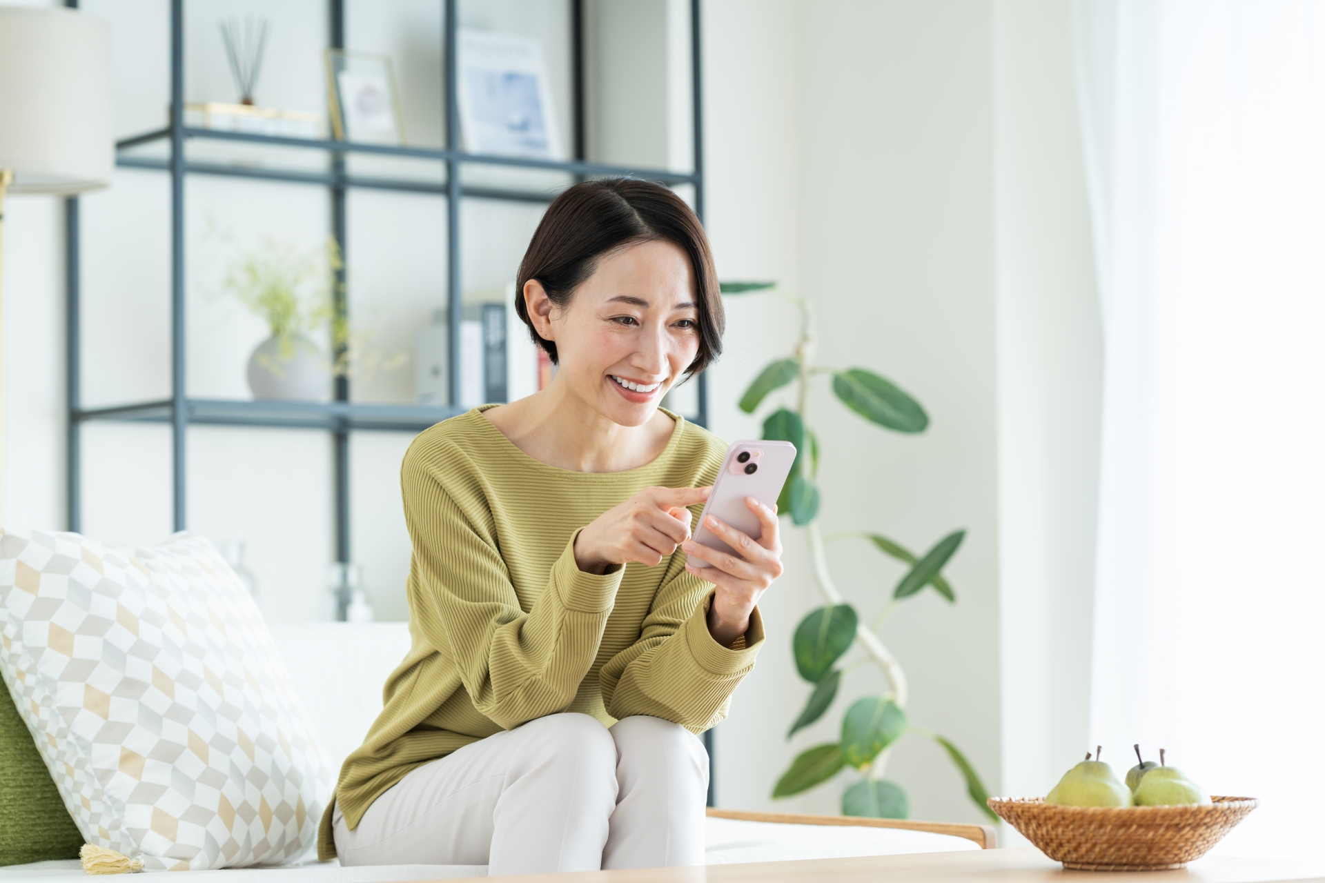 スマホを操作する笑顔の女性